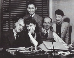 The WRAPS office in the Midland Savings Building. Front row (left to right): Charles E. Mace; an unnamed secretary; Tom Parker; and WRAPS secretary, Edna George. Standing in the back middle: Hikaru Iwasaki. Denver, Colorado, c. Mar. 1944. Courtesy of Densho and Hikaru Iwasaki